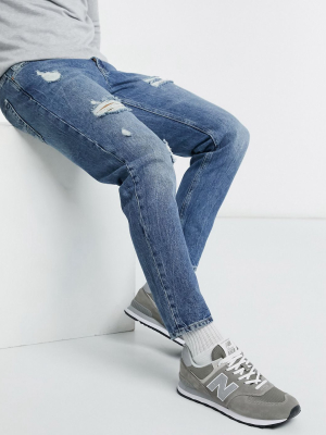 Asos Design Tapered Jeans In Vintage Mid Wash Blue With Heavy Rips