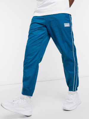 Puma Avenir Logo Woven Sweatpants In Blue