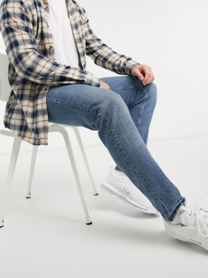 Asos Design Stretch Tapered Jeans In Vintage Mid Wash With Tint