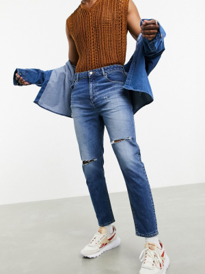 Asos Design 'responsible Edit' Tapered Carrot Fit Jeans In Mid Wash Blue With Rips