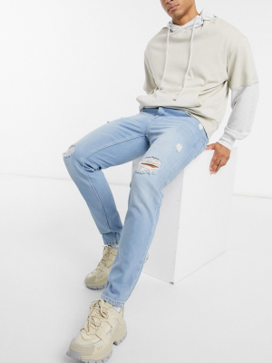 Asos Design Slim Jeans In Light Wash Blue With Heavy Rips