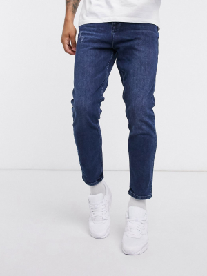 Asos Design Tapered Jeans In Dark Wash Blue With Abrasions