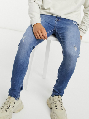 Asos Design Super Skinny Jeans In Dark Wash With Abrasions