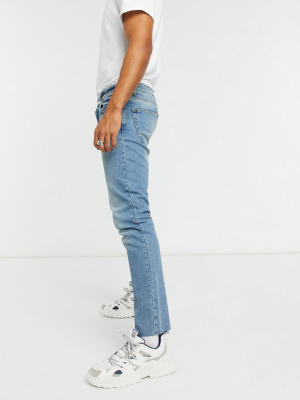 Asos Design Slim Jeans In Tinted Mid Wash Blue With Raw Hem