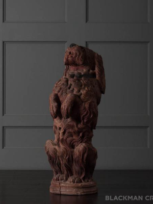 A Black Forest Carved Life-size Begging Dog Figure