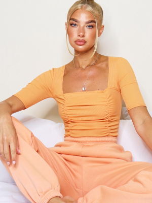 Pastel Orange Ruched Short Sleeve Bodysuit