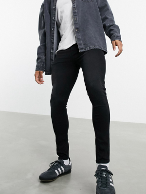 Asos Design Spray On Jeans With Power Stretch In Washed Black With Abrasions