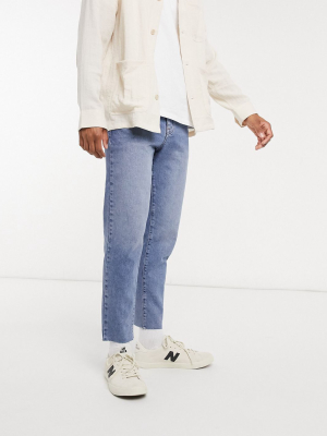 Asos Design Classic Rigid Jeans In Vintage Light Wash Blue With Raw Hem