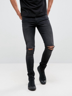 Asos Design Super Skinny 12.5oz Jeans With Knee Rips In Washed Black