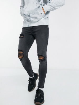 Asos Design Spray On Jeans With Power Stretch In Washed Black With Thigh Rip And Abrasions