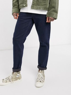 Asos Design Stretch Tapered Jeans In Indigo