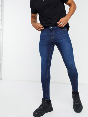 Asos Design Spray On Jeans With Power Stretch In Dark Wash Blue