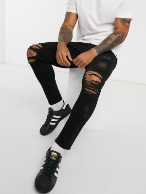 Asos Design Cropped Skinny Jeans In Black With Heavy Rips