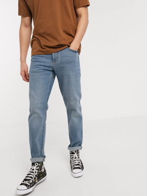 Asos Design Stretch Tapered Jeans In Mid Wash Blue