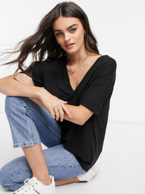 Asos Design Oversized V-neck Top With Curved Hem In Clean Rib In Black