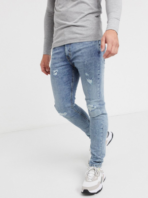 Levi's 519 Super Skinny Hi-ball Jeans In Distressed Light Wash