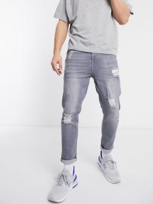 Asos Design Tapered Jeans In Washed Gray With Abrasions