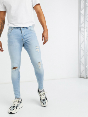 Asos Design Spray On Jeans With Power Stretch In Pale Blue With Rips