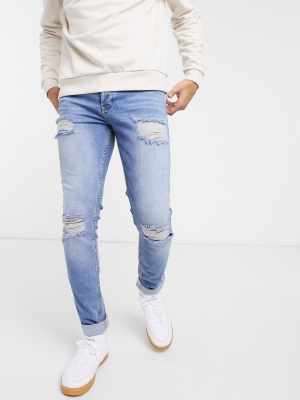 Asos Design Organic Skinny Jeans In Mid Wash Blue With Knee Rip