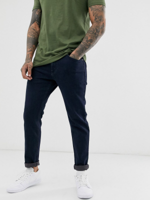 Asos Design Stretch Tapered Jeans In Indigo