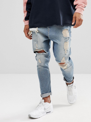Asos Design Drop Crotch Jeans In Vintage Light Wash Blue With Heavy Rips