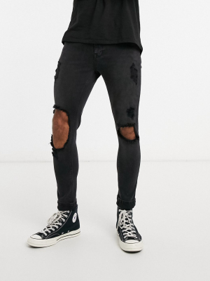 Asos Design Spray On Jeans In Power Stretch With Open Rips In Washed Black