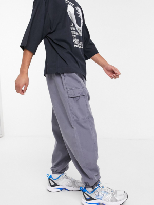 Asos Design Oversized Tapered Sweatpants With Cargo Pockets In Washed Blue