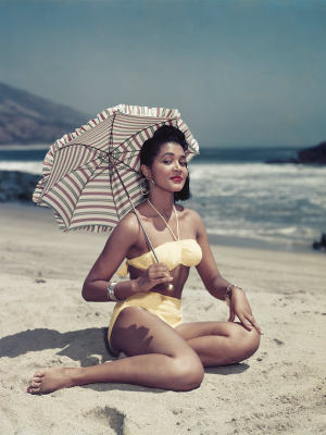 "woman On Beach Holding Umbrella" From Getty Images
