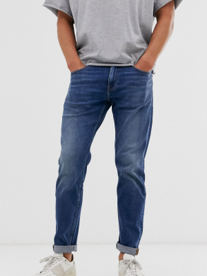 Asos Design Stretch Tapered Jeans In Dark Wash Blue