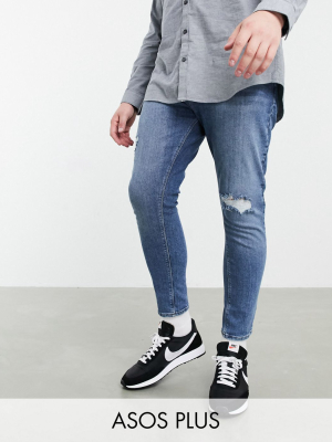 Asos Design Plus Spray On Vintage Look Jeans With Power Stretch In Mid Blue With Knee Rip