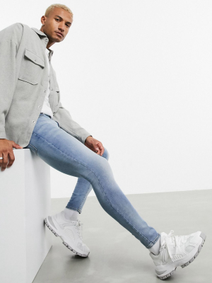 Asos Design Spray-on Jeans With Power Stretch In Light Dusty Blue