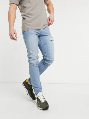 Asos Design Skinny Jeans In Vintage Light Wash With Rips