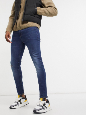 Asos Design Cropped Super Skinny Jeans In Dark Wash Blue With Abrasions