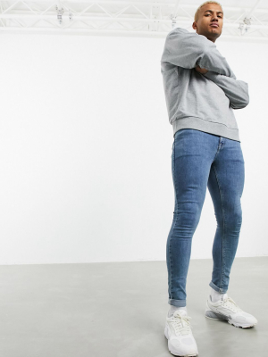 Asos Design Spray On Jeans In Power Stretch Denim In Light Wash Blue
