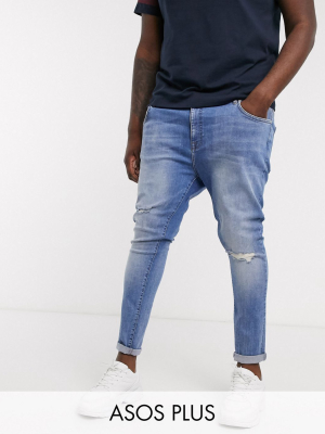 Asos Design Plus Spray On Jeans With Power Stretch In Mid Wash Blue With Knee Rips