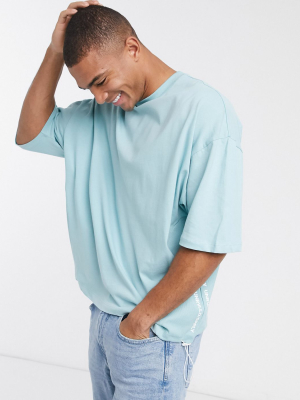 Asos Unrvlld Supply Oversized T-shirt With Side Taping And Hem Toggles