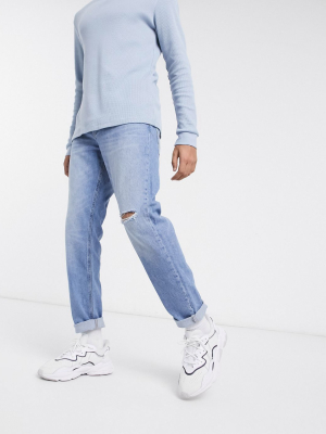 Asos Design Tapered Jeans With Knee Rip In Bright Mid-blue Wash