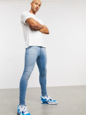 Asos Design Spray On Jeans In Power Stretch Denim In Light Wash