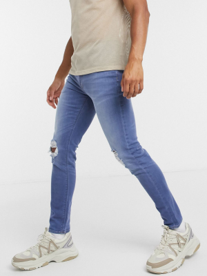 Asos Design Skinny Jeans In Light Wash Blue With Knee Rips