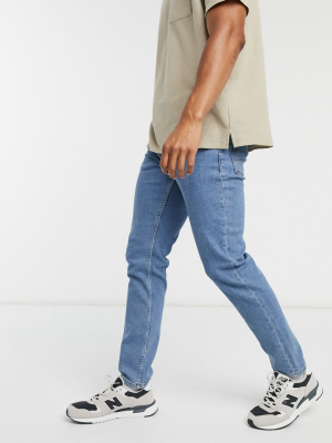 Asos Design Stretch Slim Jeans In Flat Mid Wash Blue