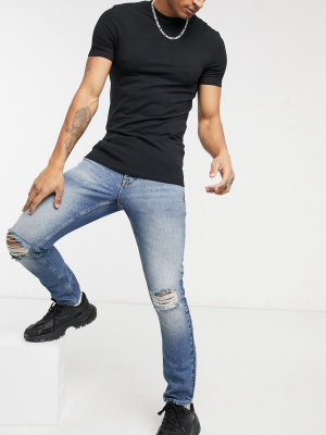 Asos Design Slim Jeans In Vintage Mid Wash Blue With Knee Tears