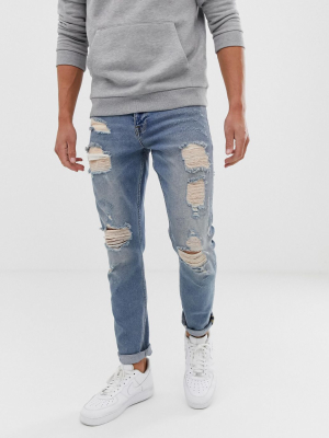 Asos Design Stretch Slim Jeans In Vintage Light Wash Blue With Heavy Rips