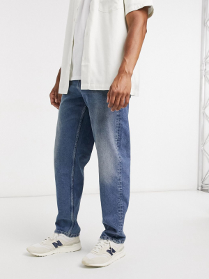 Asos Design Baggy Jeans In Dirty Mid Blue Wash