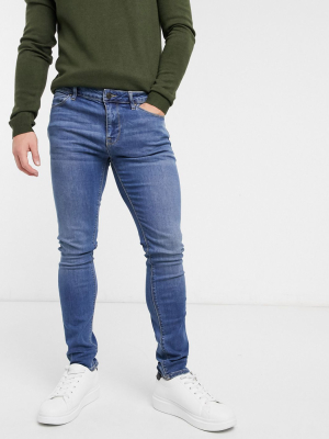 Asos Design Super Skinny Jeans In Mid Wash