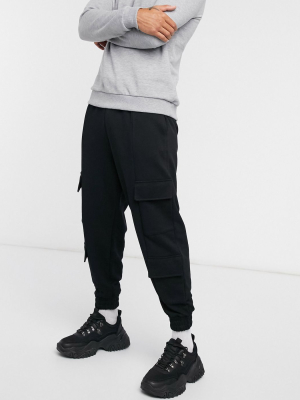 Asos Design Oversized Sweatpants With Cargo Pockets In Black