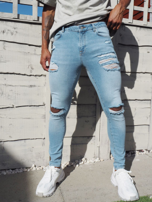 Asos Design Spray On 'vintage Look' Jeans With Power Stretch In Light Wash Blue With Heavy Rips