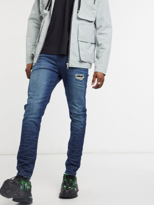 Asos Design Skinny Jeans In Dark Wash Blue With Abrasions