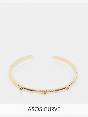 Asos Design Curve Cuff Bracelet With Bamboo And Black Stone Detail In Gold Tone