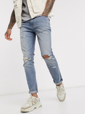 Asos Design Skinny Jeans In Vintage Mid Wash Blue With Knee Rips