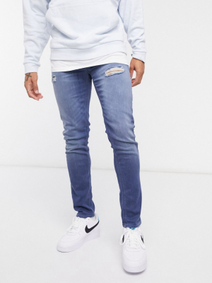 Asos Design Skinny Jeans In Dusty Blue Wash With Abrasions